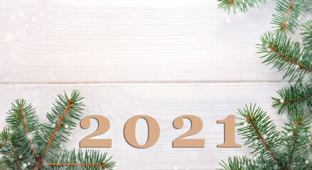 Happy new year 2021!Christmas fir tree on a white wooden board and copy space for your text. Banner.Flat lay