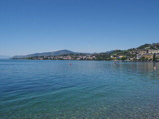 Lake Geneva and european Montreux city in canton Vaud in Switzerland, clear blue sky in 2017 warm sunny summer day on July.