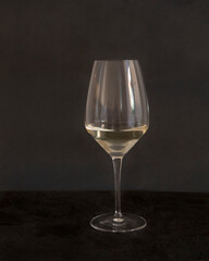 Glass of Pinot Grigio wine on black background. Close up front view