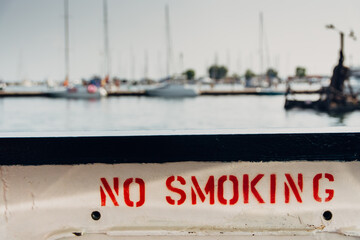 No Smoking Sign Written On The Side of a Ferry Boat