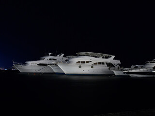 Diving safari yachts anchored at night marina