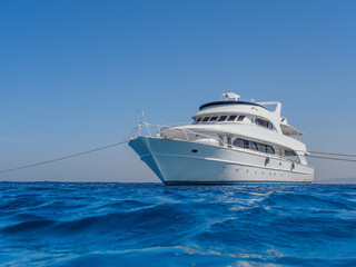 Fototapeta na wymiar White yacht in the blue tropical sea, diving safari boat for liveaboard