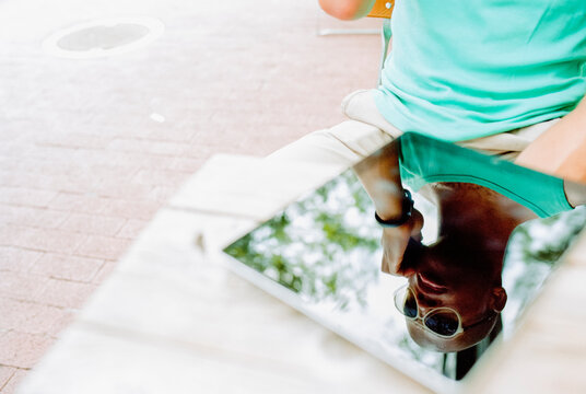 Stylish man refection in his technology while sitting at a cafe