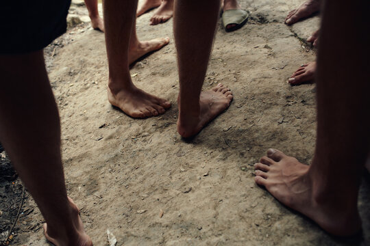 Close up of barefoot of a group of teenagers in the nature
