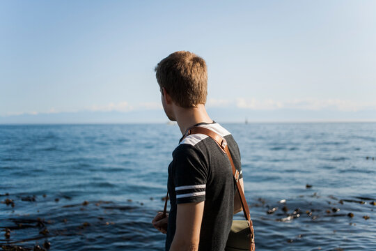 Young man looks out to sea
