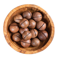 Macadamia nuts in wooden bowl isolated on white. Top view.