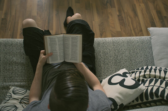Boy reading bible in the coach