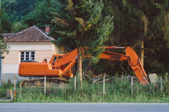 Orange excavator inside the yard