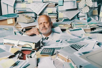 Fotobehang Stressed businessman overwhelmed by work © stokkete