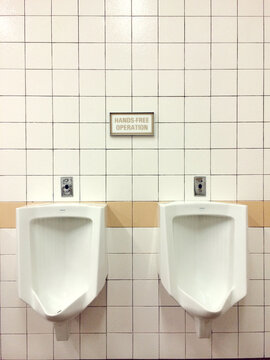 Two urinals next to each other