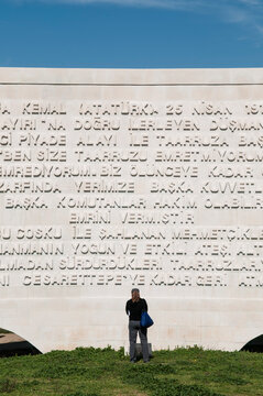 Woman Reading A Plaque At A Turkish War Memorial, Gallipoli Peninsula, Turkey.