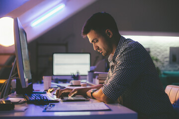 Programmer Looking at a Computer Code on a Tablet