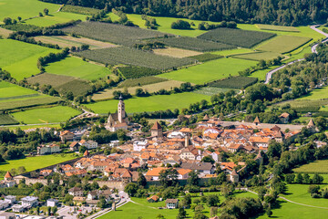 Fototapeta na wymiar Superb aerial panoramic view of the fortified town of Glurns Glorenza and the apple fields around it, Val Venosta, South Tyrol, Italy