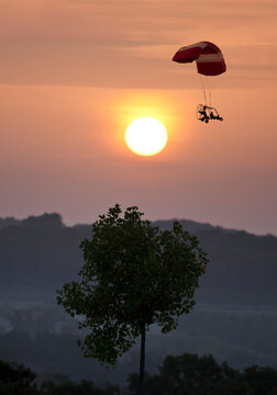 Powered Parachute Flying Over the Ozark Mountains at Sunrise