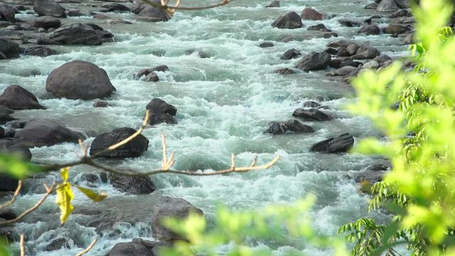 View of flowing stream amidst rocks, Lamjung, Nepal