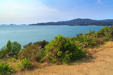 View along the coastline of the scenic Coromandel Peninsula, New Zealand, looking from Ruffin Peninsula towards Oamaru Bay