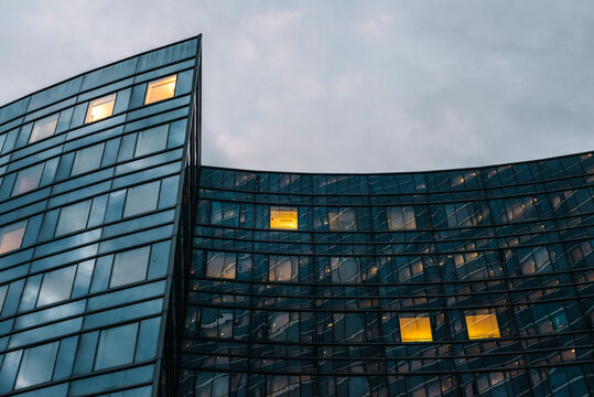 Illuminated office windows in contemporary building at twilight