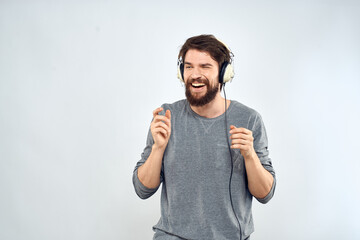 Man in headphones listens to music lifestyle modern style technology light background