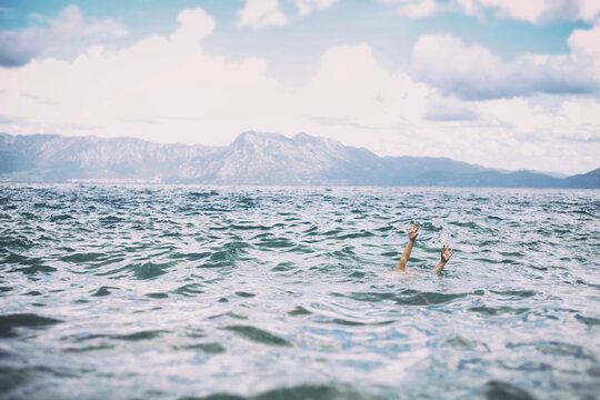 Hands of a child in the sea