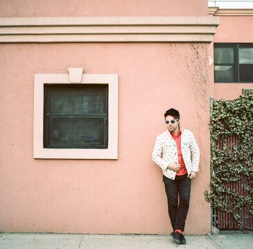 Hipster man hanging outside a seedy hotel in Brooklyn