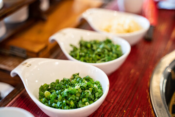 Green onions, cliantro, and garlic, traditional Sichuan hotpot seasonings in China.