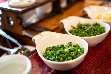 Green onions, cliantro, and garlic, traditional Sichuan hotpot seasonings in China.