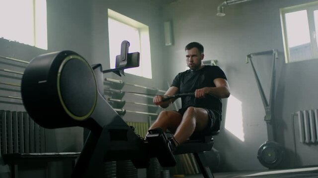 Serious Man Train on Rowing Machine .