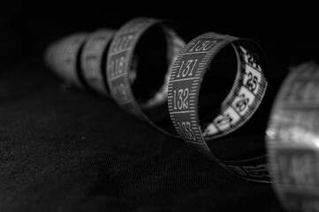 Black and white tailor's meter arranged in a spiral