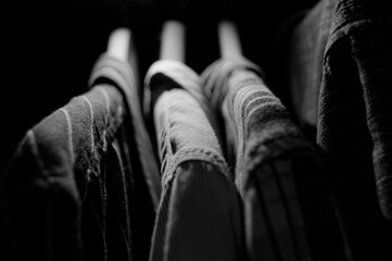 Men's shirts hanging on a hanger in the closet in Black and white