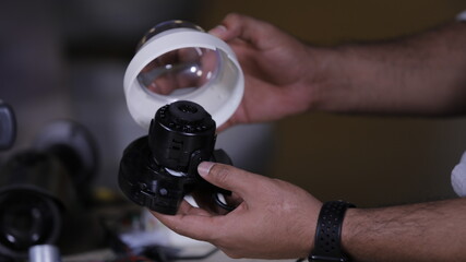 A man repairing CCTV camera in service center  