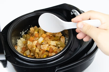 Macro video of a multicooker. The man opens the pan and mixes the dish. The concept of cooking automation and ease in the kitchen.