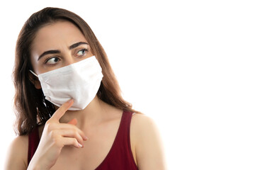 Young woman wearing medical face mask, studio portrait
