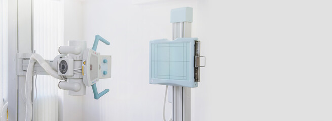 A radiography X-ray machine in radiology xray examination room, nobody present.
