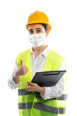 Female engineer wearing protective face mask , protective workwear