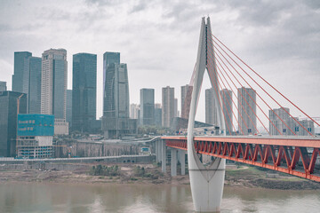 Panorama view of the Qiansimen bridge and skyline in Chongqing, China, on a cloudy day.