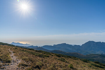 View of the Alicante coast from the top of the Aitana mountain with the sun in the left.
