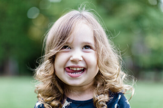 Happy Toddler Looking Playful With Her Tongue Out