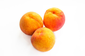Ripe peaches on a white background and a tree background