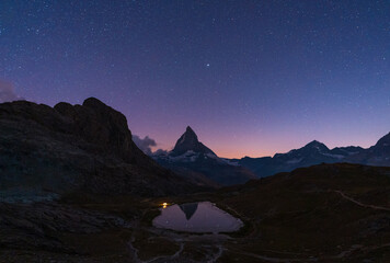 A tent at the Riffelsee, with the Matterhorn in the background, on a clear night. © sanderstock