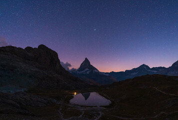 A tent at the Riffelsee, with the Matterhorn in the background, on a clear night.