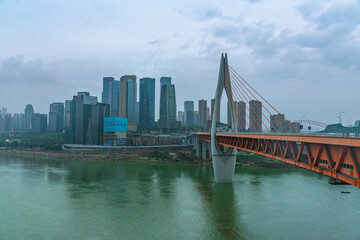 Panorama view of the Qiansimen bridge and skyline in Chongqing, China, on a cloudy day.