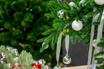 Christmas tree branches decorated with balls of red and silver colors