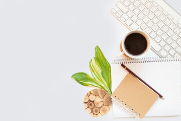 Office table top. Workspace with blank board with clip, keyboard, stationery, pencil, coffee cups on light gray background. Place for text