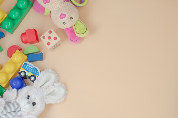 children's wooden toys, blocks, plush hare on a beige background. the view from the top