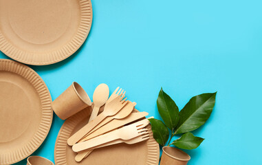 eco-friendly paper-cardboard dishes, fork of knives, glasses, plates on an empty background, space for text, zero plastic.