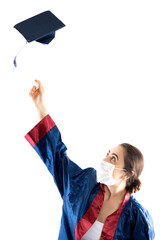 A girl wearing a surgical face mask and graduation outfit.