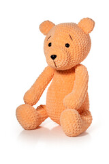 Knitted toy - orange bear on white background. Full depth of field. With clipping path.