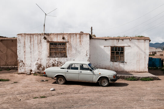 Old car outside a house, Saray Tash village, near the border of China and Kyrgyzstan.