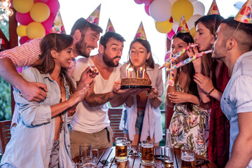 Group of friends celebrating birthday together