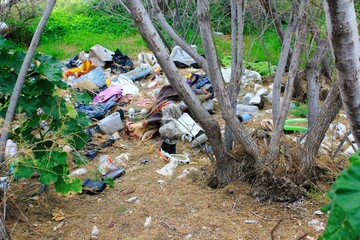 Pile of garbage in forest, trash left by illegal immigrants at coastal site of Attica in Greece, March 2 2020.